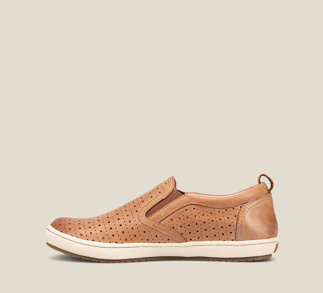 outside image of Court Caramel slip on sneaker with perforations and rubber outsole.