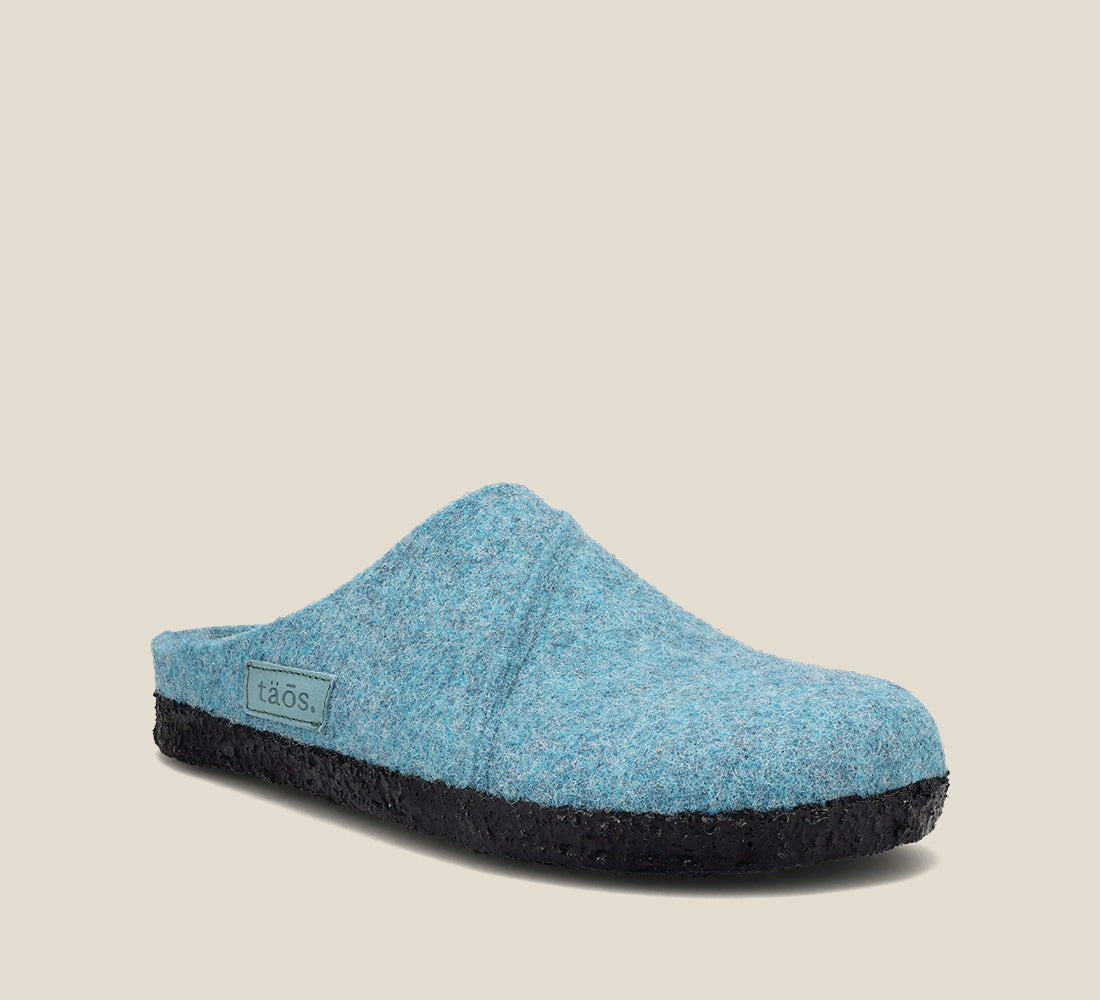 "Hero image of Wooled Class Turquoise clog with featuring a removable footbed with arch & metatarsal support, & TR outsole."