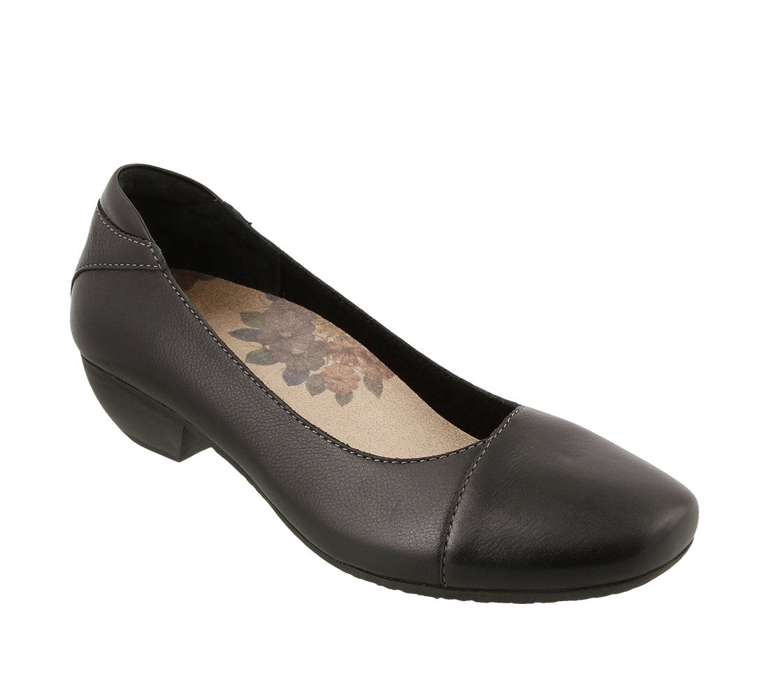 Three quarter angle of Black leather slip on women's casual shoe featuring removable footbed and rubber outsole - size 6